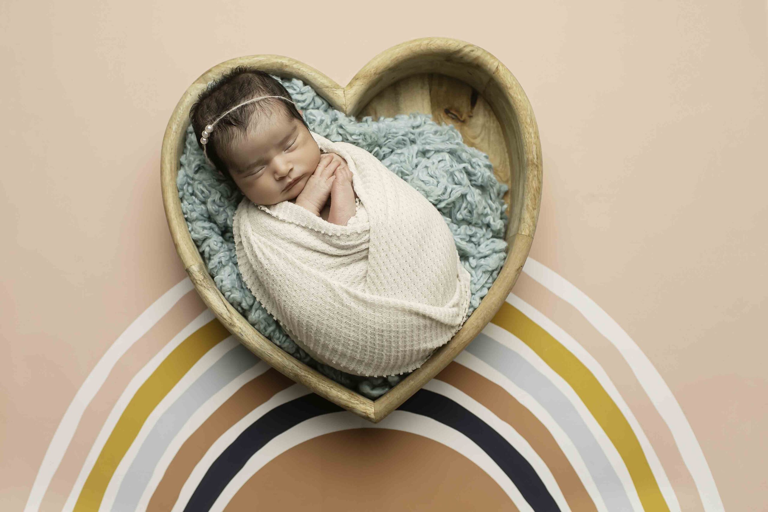 Newborn Baby Girl in heart bowl rainbow