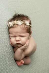Newborn Baby Girl on Swing side laying 