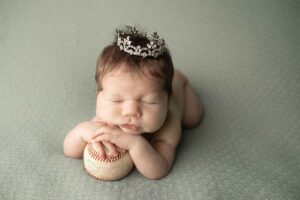 Newborn Baby Girl on a baseball with tiara 
