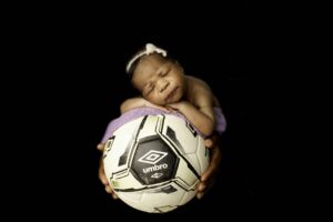 Chunky Monkey Newborn Baby Girl in Studio with soccer ball