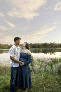Maternity session with mama in white shirt in nature with dad at the lake