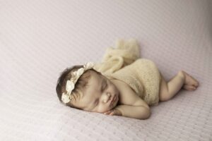 Newborn Baby Girl on a Purple Backdrop