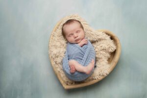 Newborn Baby Boy in White in heart bowl