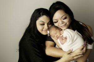 Fort Worth Newborn Baby Girl posed with mom and surrogate 
