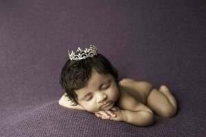 Newborn Baby Girl on purple with tiara 