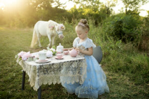 Child as a princess tea party with a unicorn
