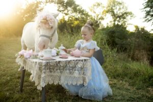 Child as a princess tea party with a unicorn