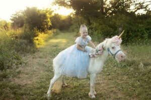 Child as a princess riding a unicorn