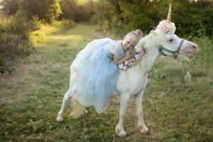 Child as a princess riding a unicorn
