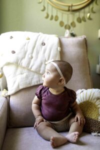 Chunky Monkey Newborn Girl at sitting up milestone
