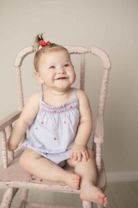 Sitter Milestone Baby Sitting in pink high chair