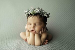 Newborn Girl in Froggy Pose with Flower Halo 