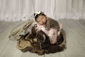 Newborn Baby Girl on Saddle 