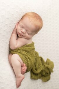 Newborn Baby Boy with Red Hair with green wrap