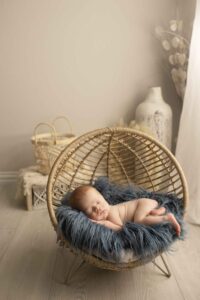 Newborn Baby Boy with Red Hair in boho basket