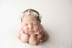 Newborn Baby Girl on White Blanket in Froggy Pose