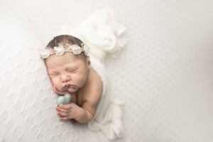 Newborn Baby Girl on White Blanket