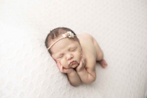 Newborn Baby Girl on White Blanket side laying