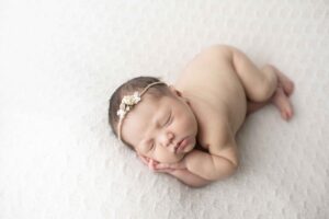 Newborn Baby Girl on White Blanket