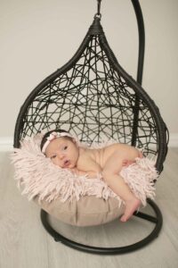 Newborn Baby Girl in black hanging basket