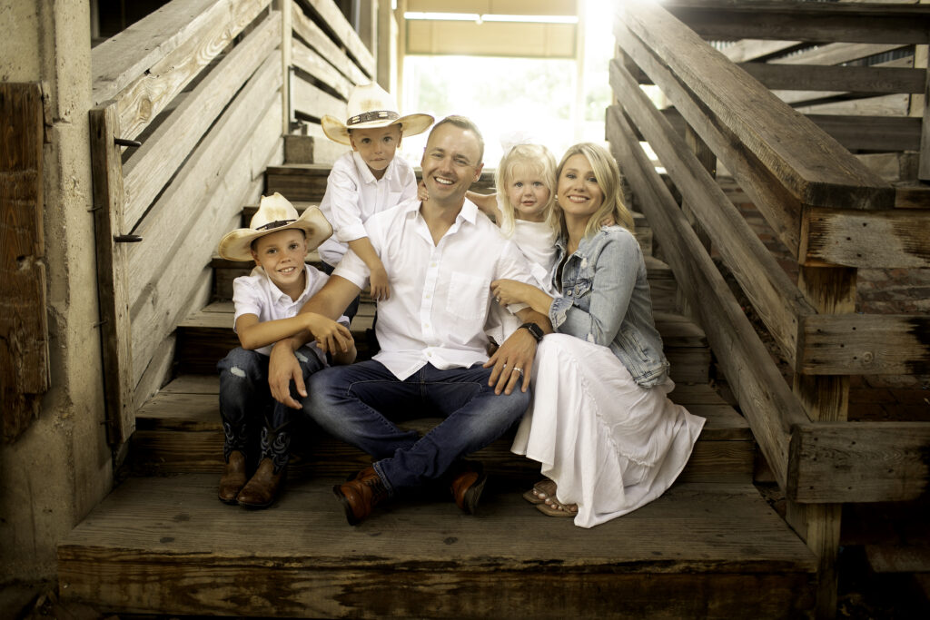 Family enjoying a fun moment at the Fort Worth Stockyards, capturing Western charm and family love during a Chunky Monkey Photography session