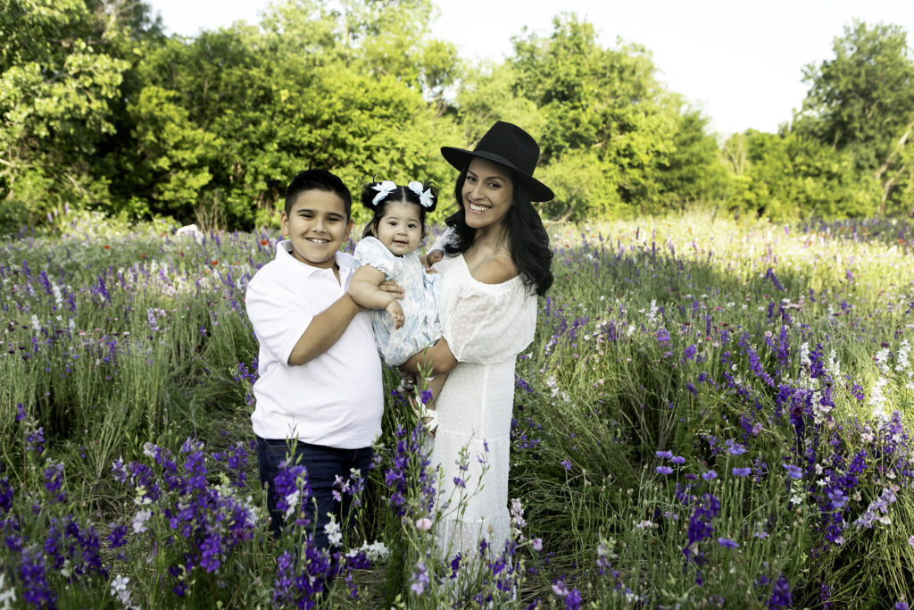 Family posing together in a field of wildflowers, enjoying a serene and colorful moment during a Chunky Monkey Photography session