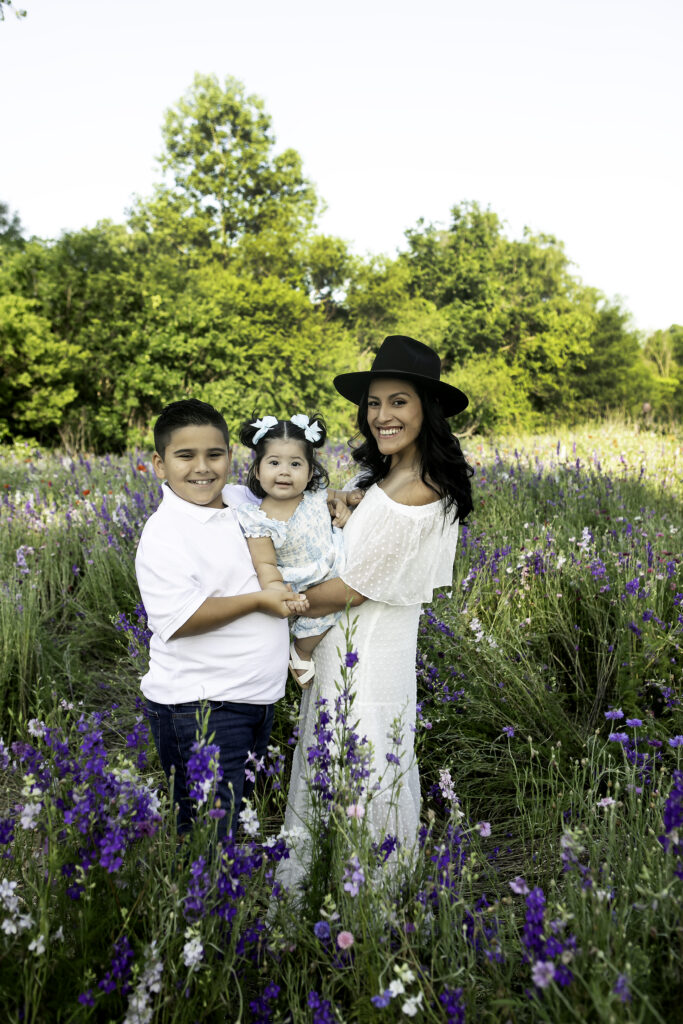 A fun and lighthearted moment captured in a wildflower field in Richardson, TX, beautifully framed by Chunky Monkey Photography