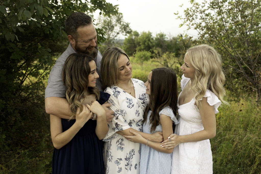 A peaceful family photoshoot at Tandy Hills, Fort Worth, with three sisters sharing a special connection as they prepare to say goodbye to their oldest sister heading off to college