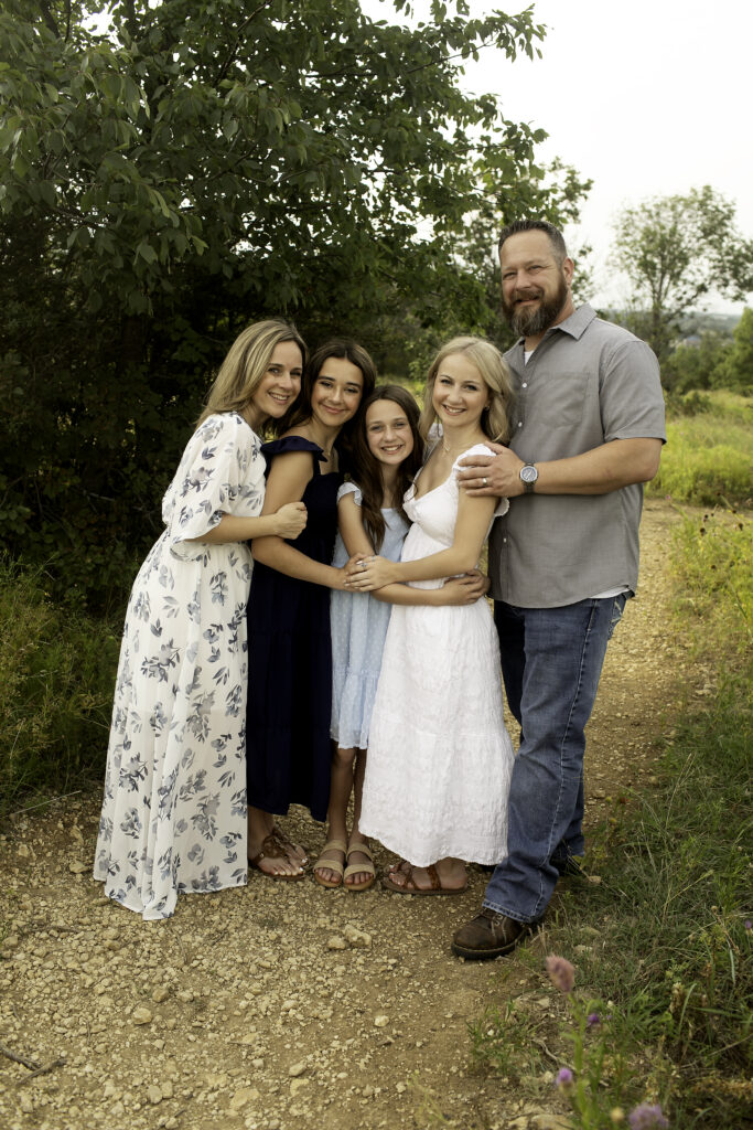 A natural, heartfelt moment at Tandy Hills in Fort Worth, where three sisters enjoy one last photoshoot together before the oldest embarks on her college journey