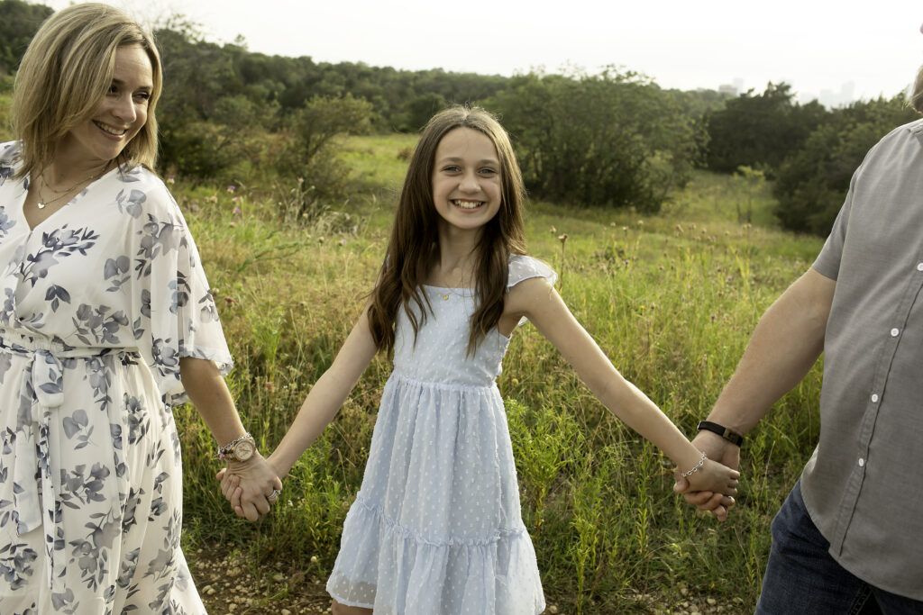 A joyful family gathering at Tandy Hills, Fort Worth, with three sisters sharing laughter and memories before the eldest sister heads off to college