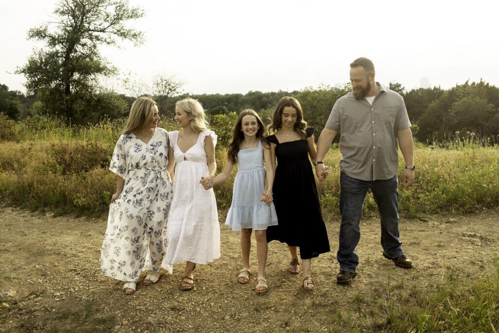 Candid family moments at Tandy Hills in Fort Worth, showcasing the love and bond between three sisters and their parents before the eldest heads off to college