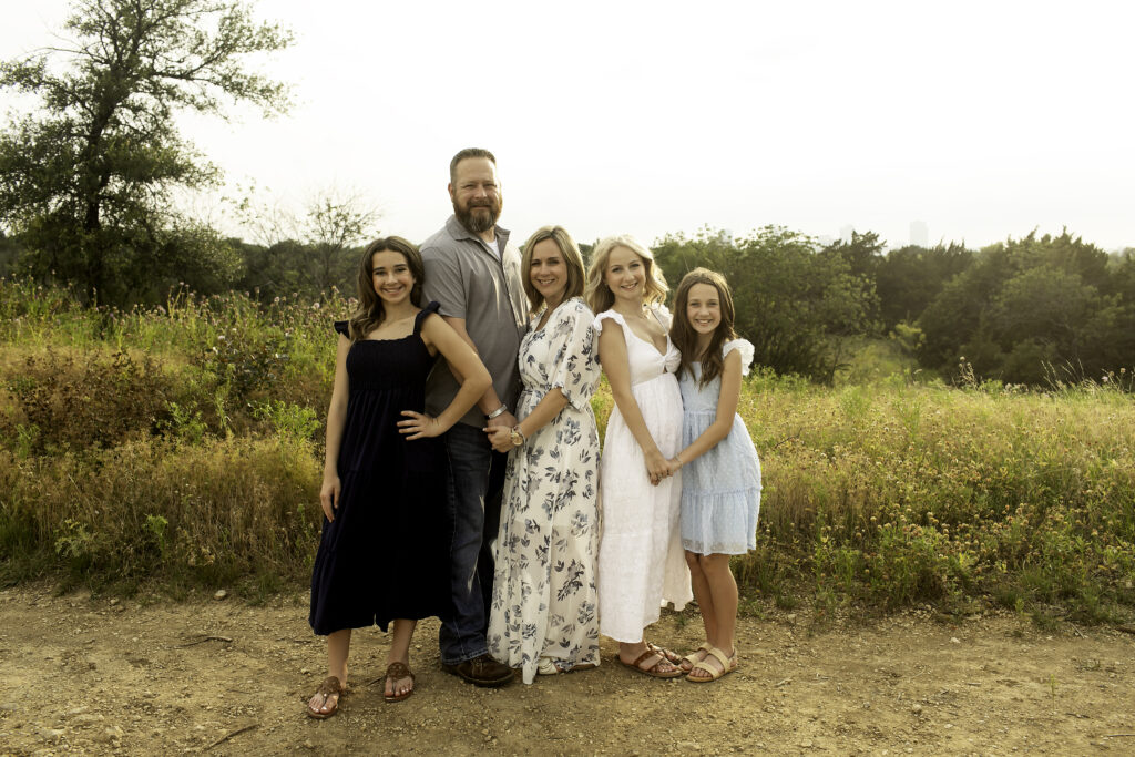 The family of five gathered at Tandy Hills in Fort Worth, with the three sisters showing their closeness, celebrating the upcoming milestone of the eldest going to college