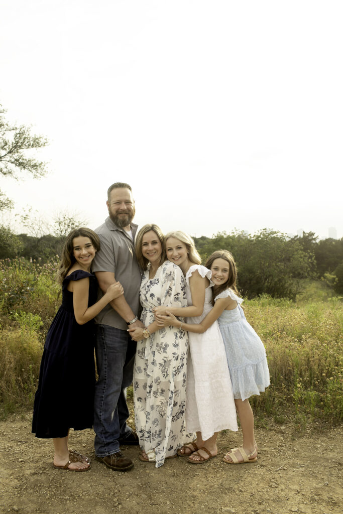 A heartfelt family photoshoot on the rolling hills of Fort Worth, where three sisters share special moments together, including a big farewell for the oldest heading to college