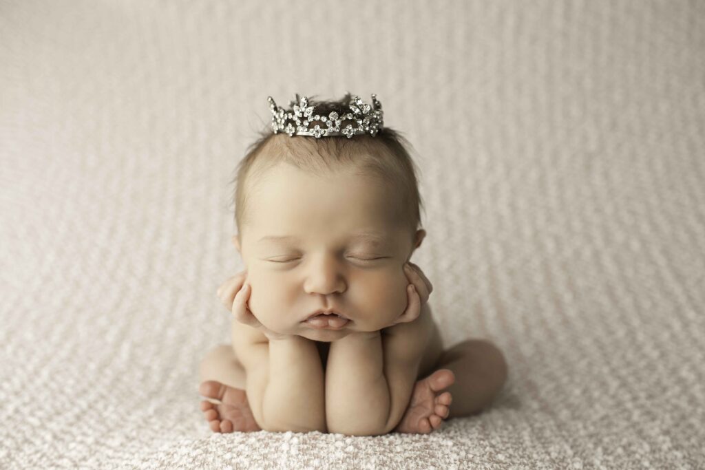 A serene newborn posed gently on a soft white blanket, radiating warmth and innocence, captured perfectly by Chunky Monkey Photography