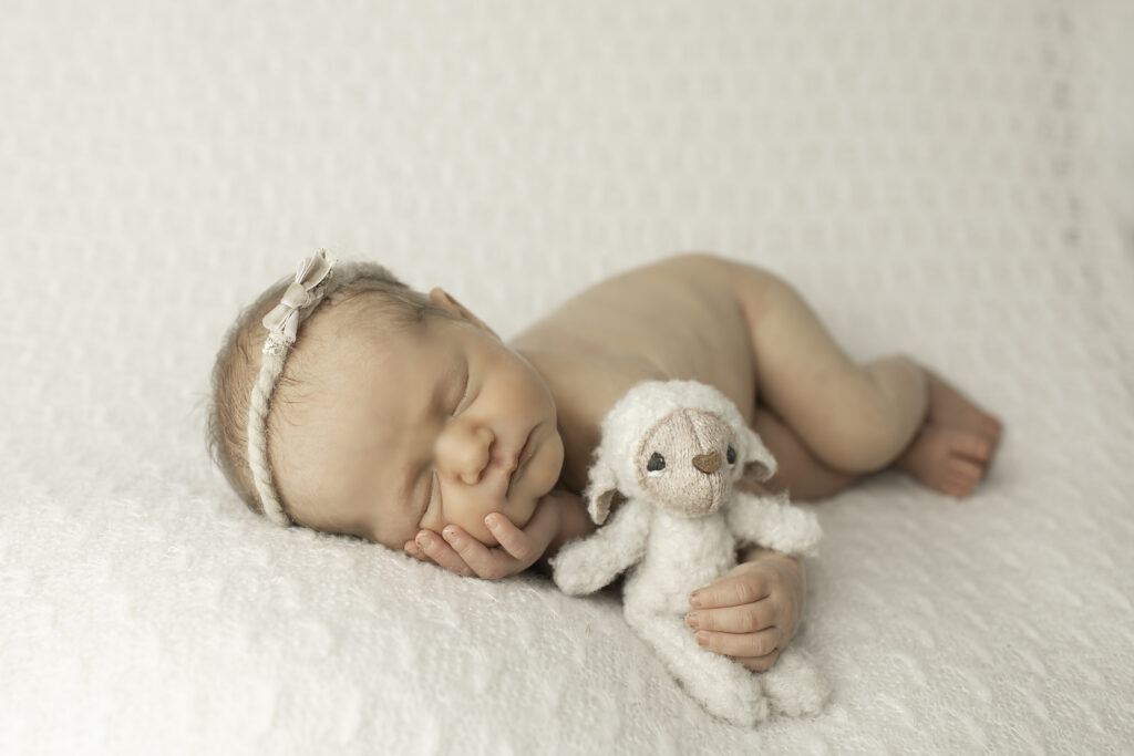 A simple yet elegant pose of a newborn girl resting peacefully, radiating warmth and innocence, captured by Chunky Monkey Photography