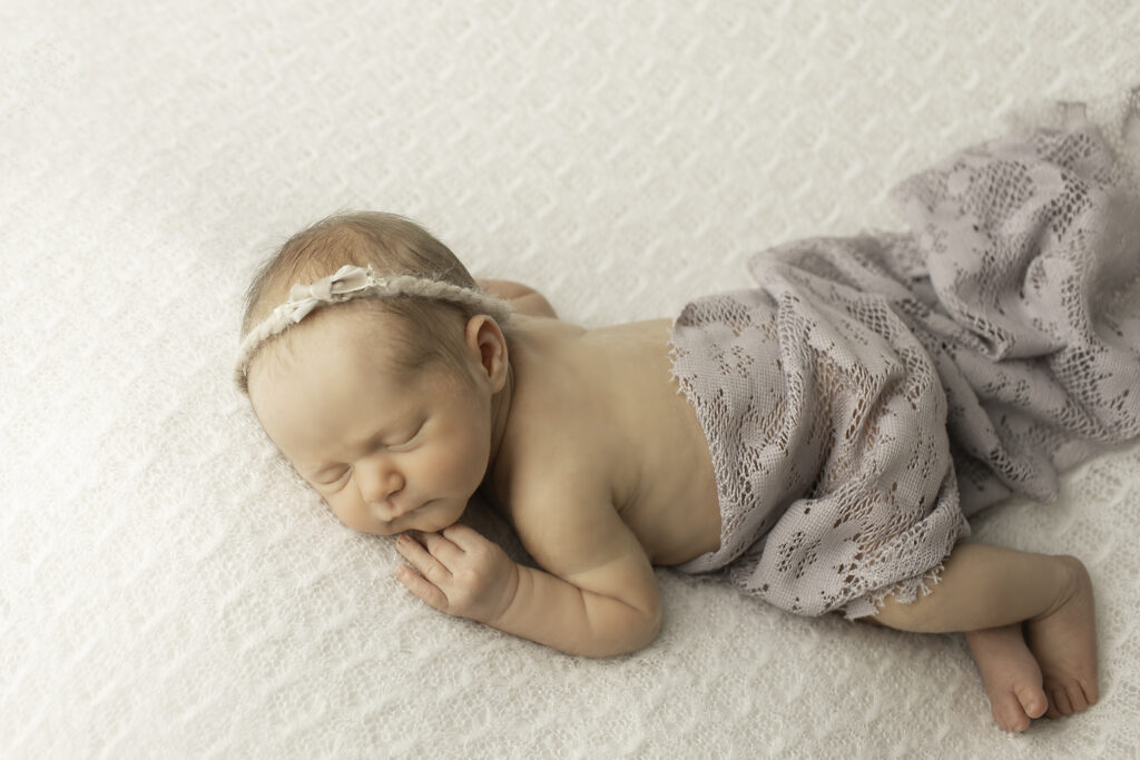 Chunky Monkey Photography captures the beauty of simplicity with a newborn girl posed peacefully on a soft blanket