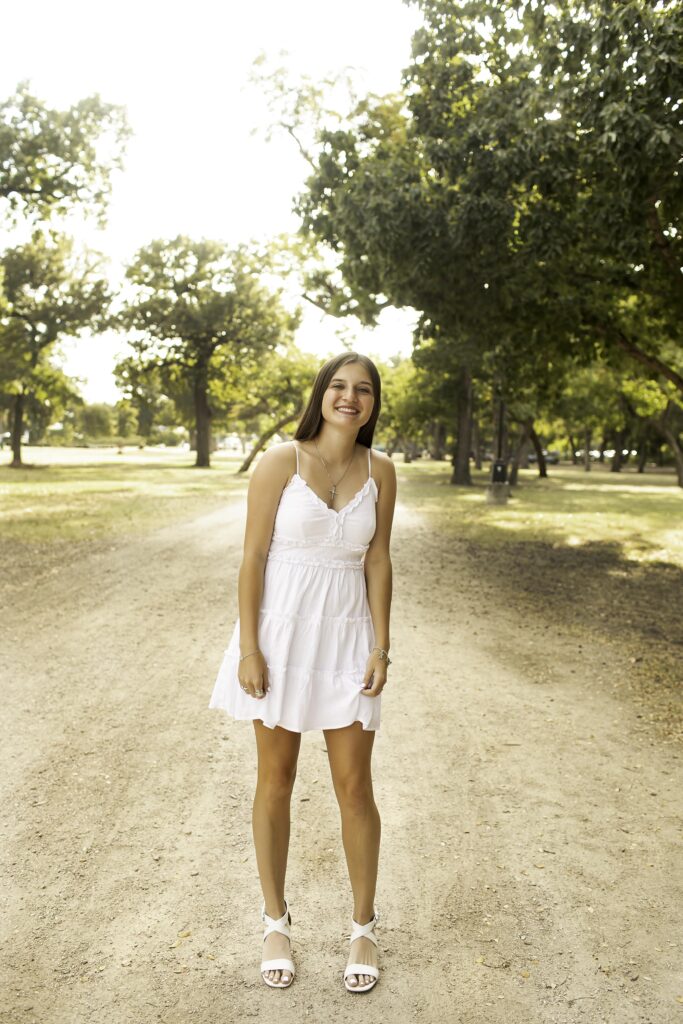 Portrait of senior girl with the stunning Trinity Park landscape as her backdrop, capturing a memorable moment