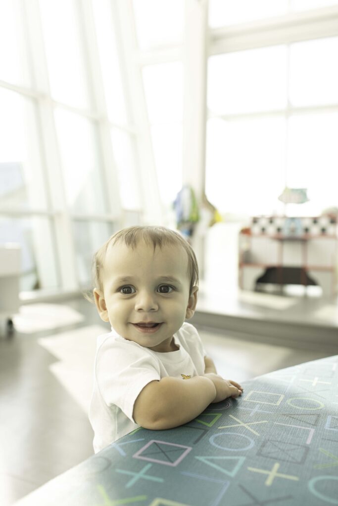 A joyful 1st birthday photoshoot at the Library in Fort Worth, TX, capturing the little one surrounded by books, celebrating their milestone in a meaningful setting