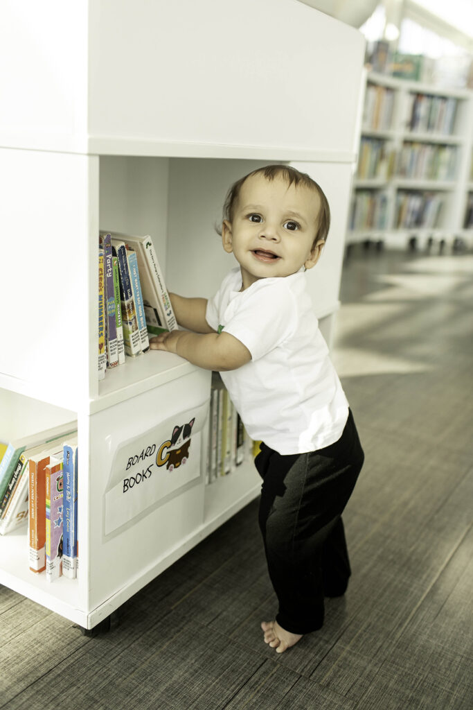 A 1-year-old celebrates their first birthday at the Library in Fort Worth, TX, with a festive photoshoot that captures the charm of this unique and educational setting