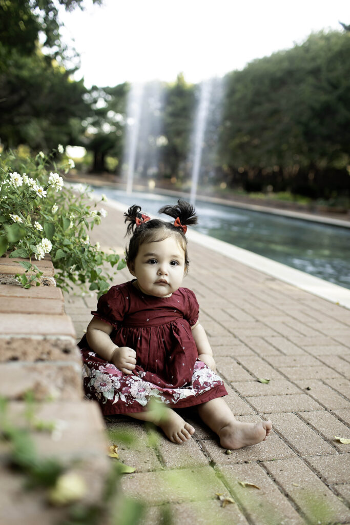 Captured in the beautiful Clark Gardens of Mineral Wells, TX, a little one celebrates their first birthday, sitting amidst the stunning natural landscape