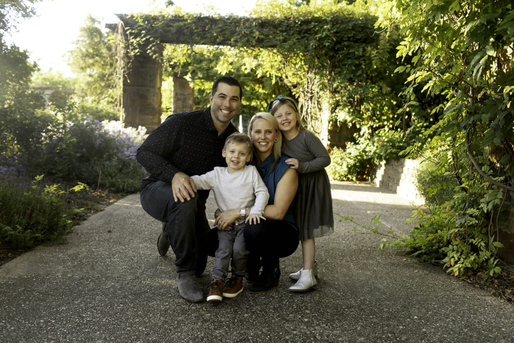 Family posing together in the beautiful Fort Worth Botanical Gardens, capturing memorable moments amidst vibrant flowers during a Chunky Monkey Photography session