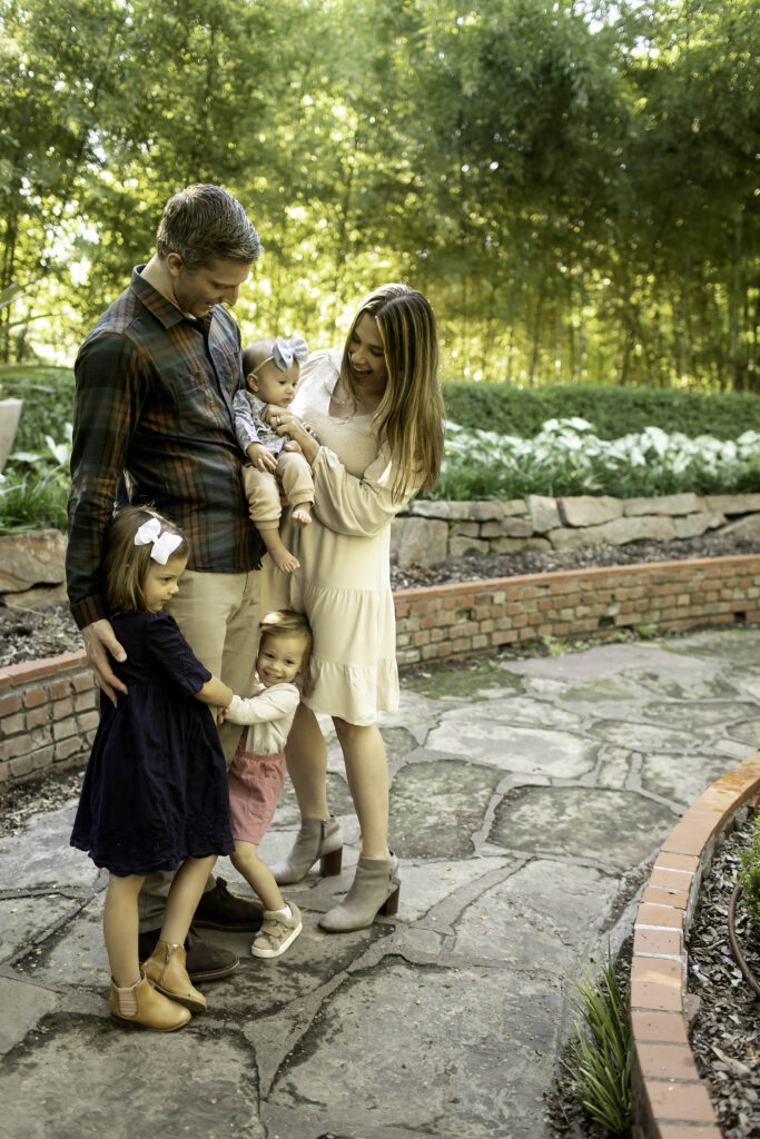 Family of five enjoying a moment of togetherness in the peaceful surroundings of Chandor Gardens