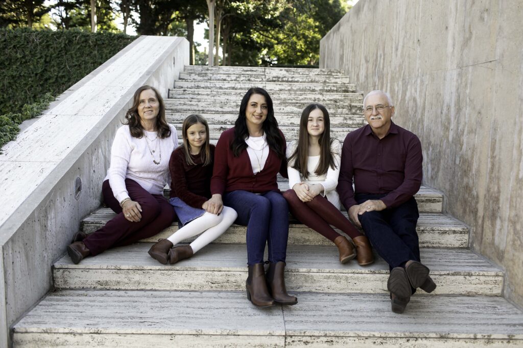 Family portrait session at the Kimbell Art Museum in Fort Worth, Texas, where the family poses in front of the museum’s iconic, modern architecture and stunning art collections. The sleek, minimalist design of the building, paired with its beautiful landscaping and sculptures, creates an elegant and sophisticated backdrop. The family’s connection shines through in this cultured, artistic setting, capturing a timeless moment in one of Fort Worth’s most celebrated cultural landmarks