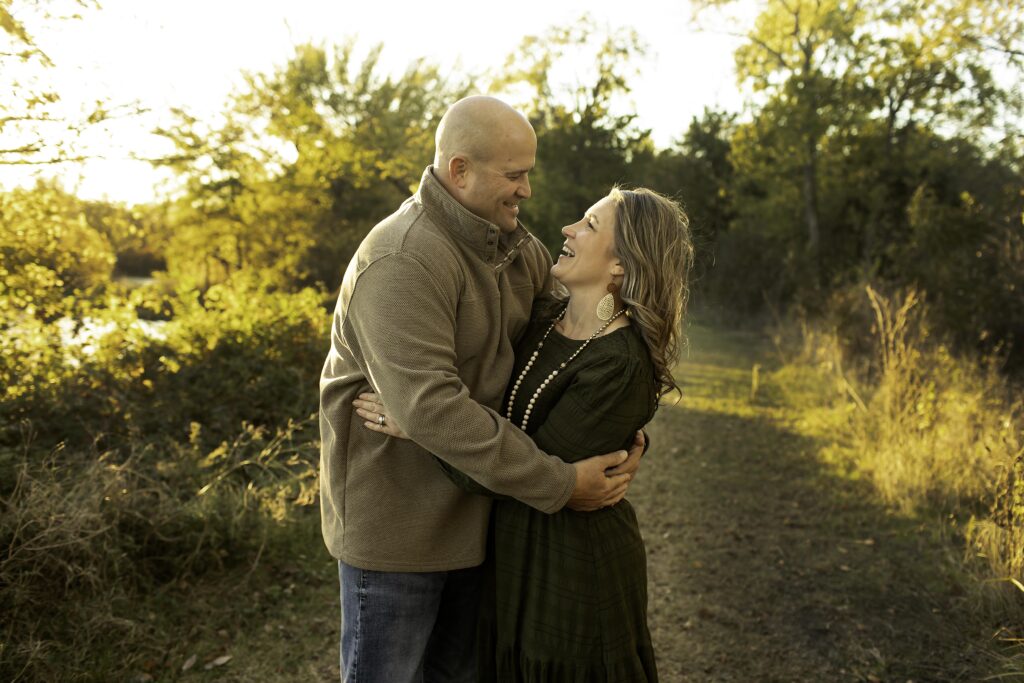 Mom and dad sharing a loving moment together at Northwest Community Park, smiling in the fresh air