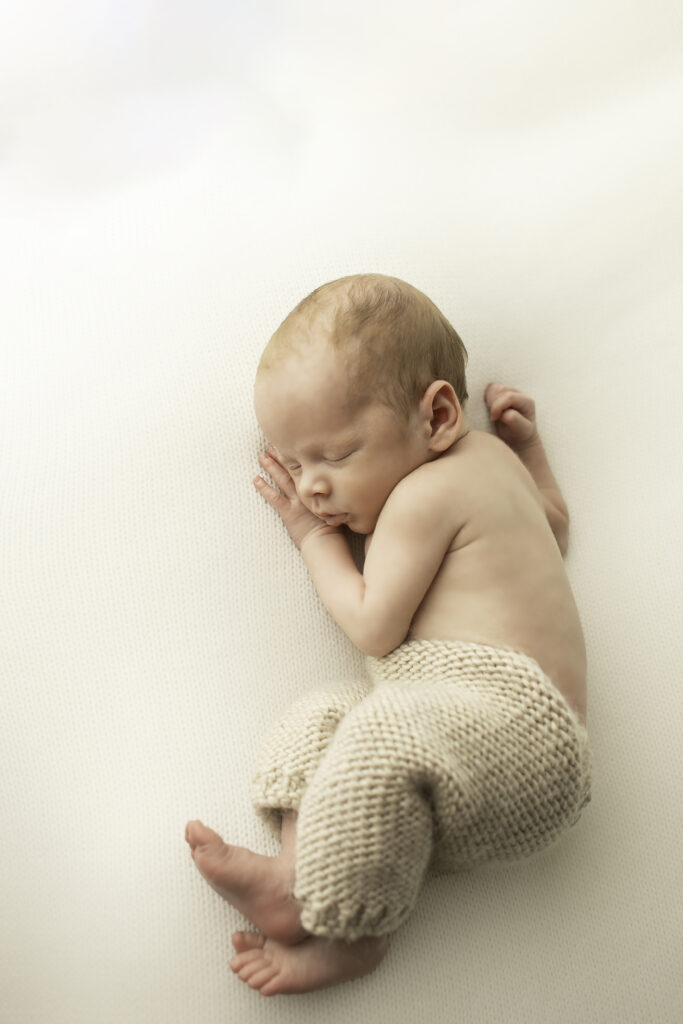 Serene newborn portrait with soft, natural lighting highlighting delicate features