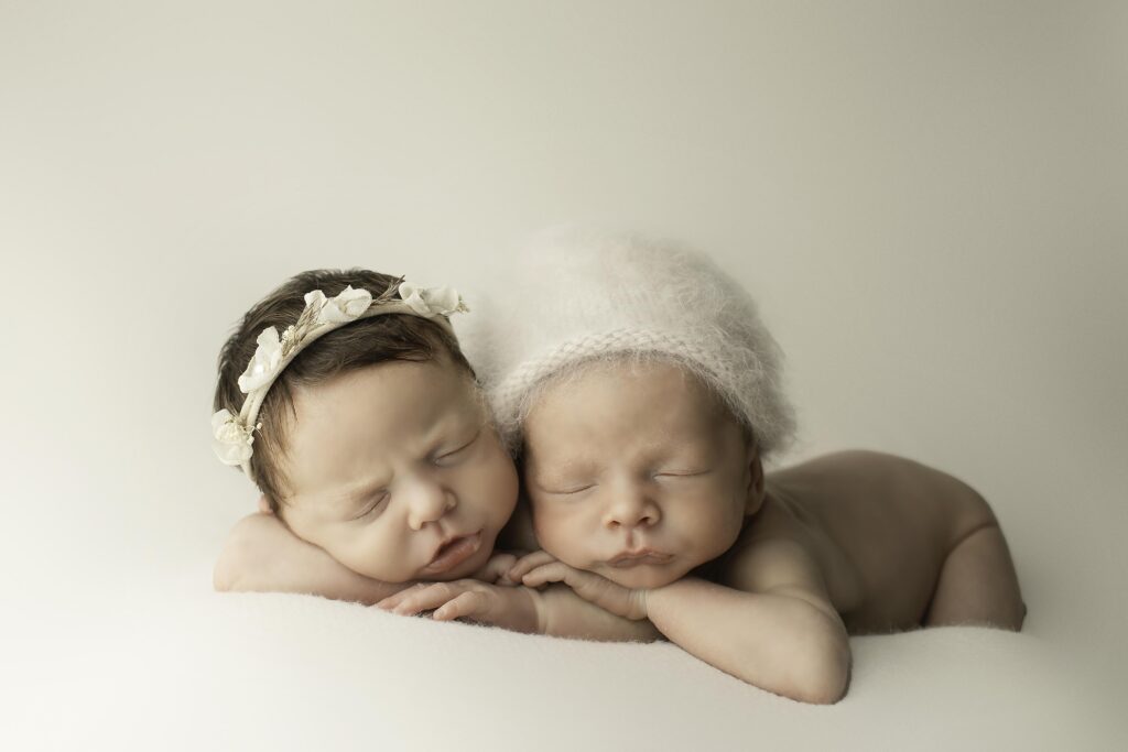 twin newborns curled up in a cozy pose, radiating innocence and calmness, beautifully captured