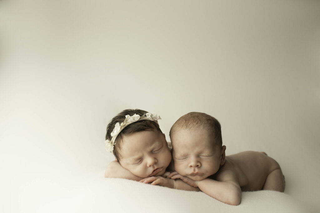 Close-up of newborn twins peacefully sleeping in cozy blankets